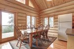 Dakota log Cabin dining room with vaulted ceilings and view. 